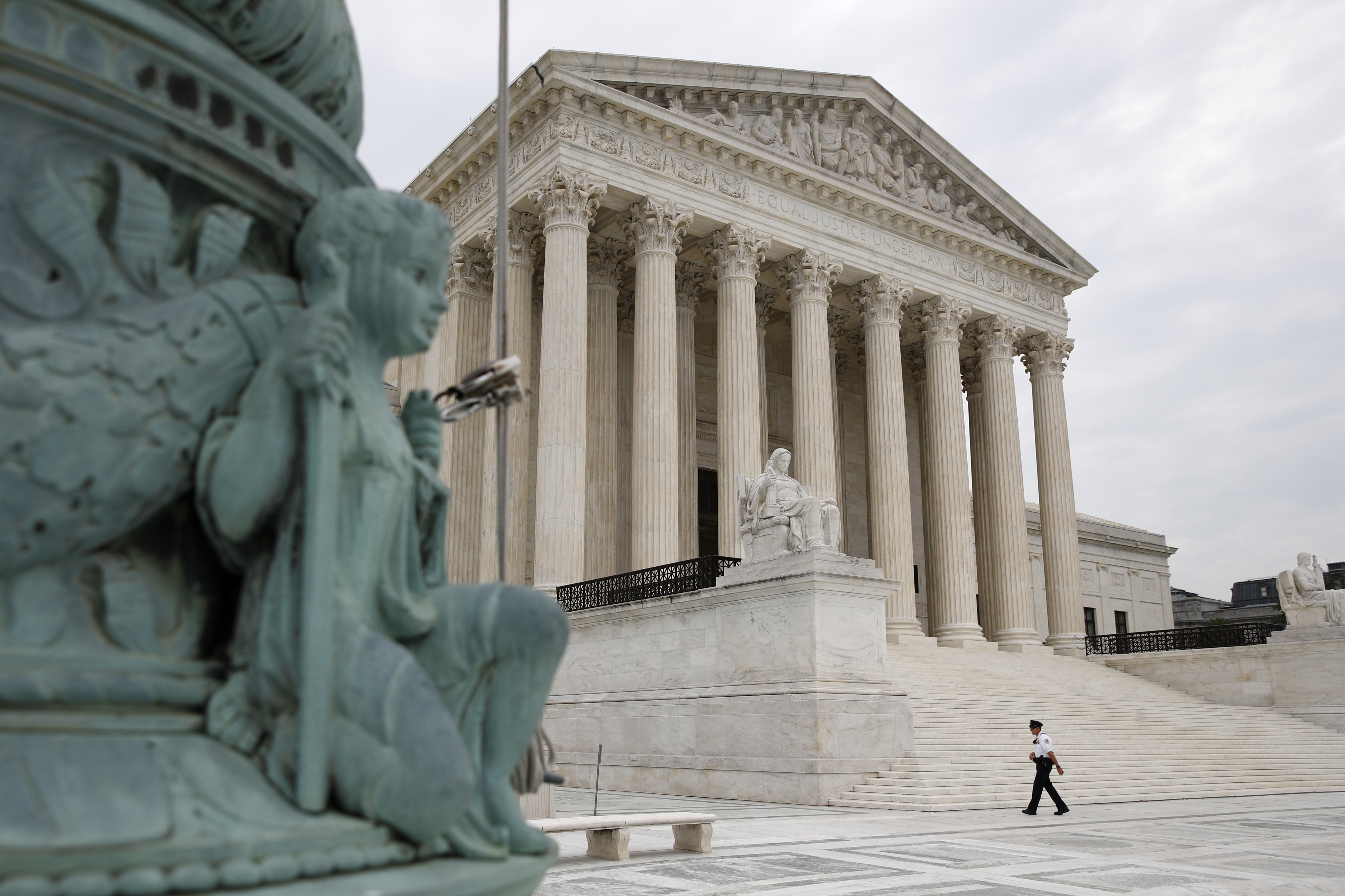 A police officer walks outside the Supreme Court on Capitol Hill in Washington, July 6, 2020.